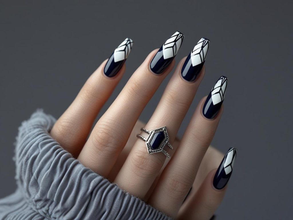 Geometric nail design with black and white triangles for 2025
